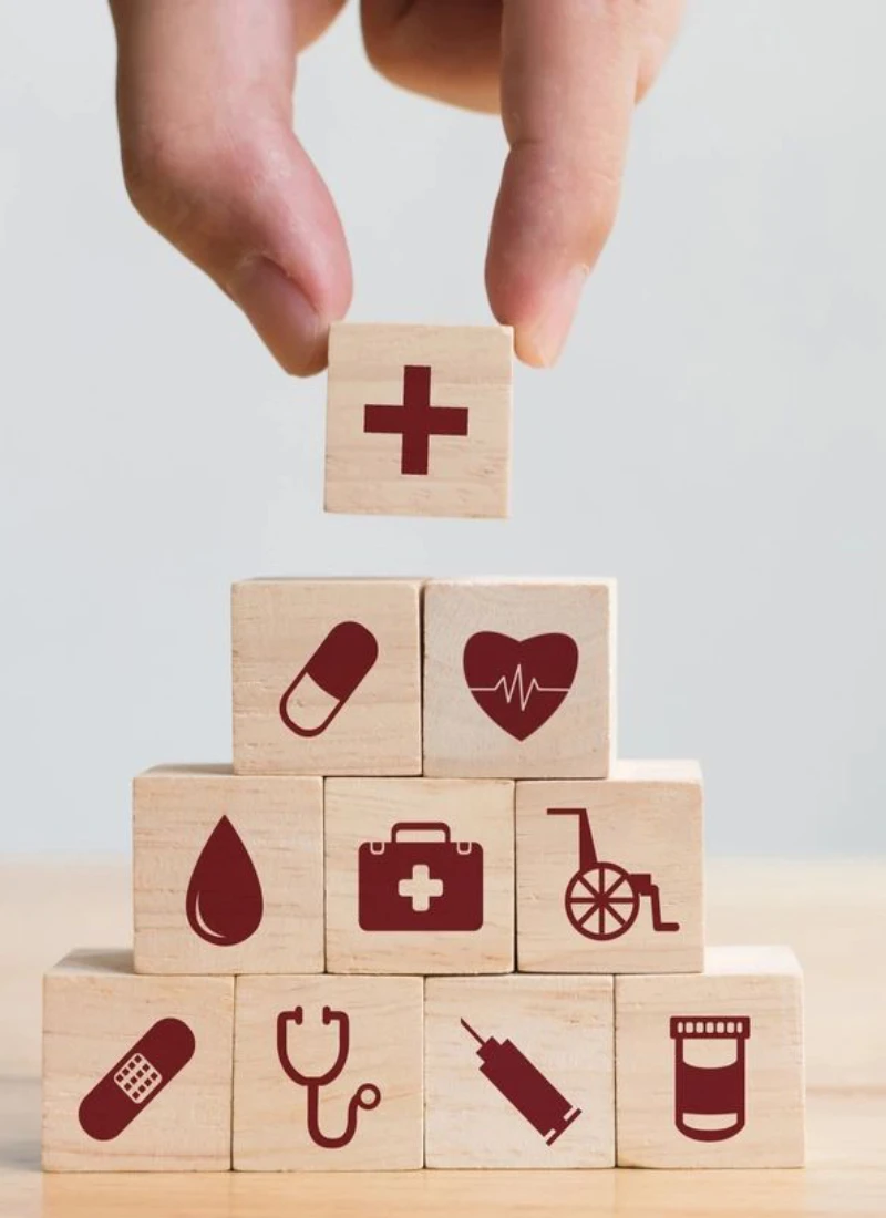 A person holding onto blocks with medical symbols on them